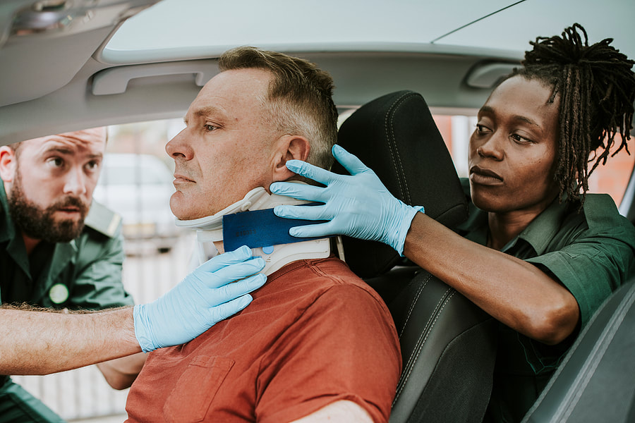 a man in a car getting his neck checked