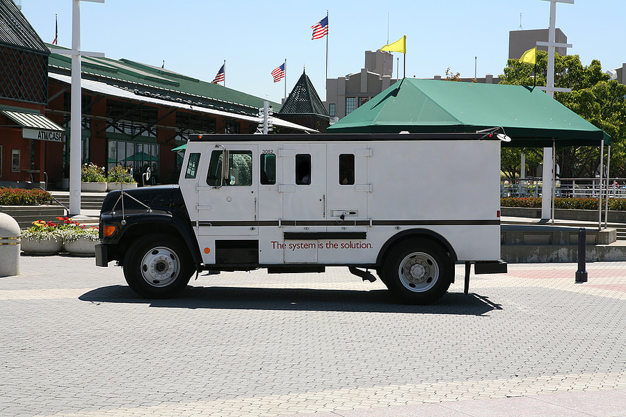 a white utility truck parked in front of a building